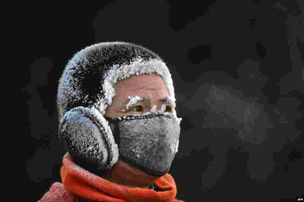 A resident is covered in frost while exercising outdoors during cold weather in Shenyang, in China's northeast Liaoning province.
