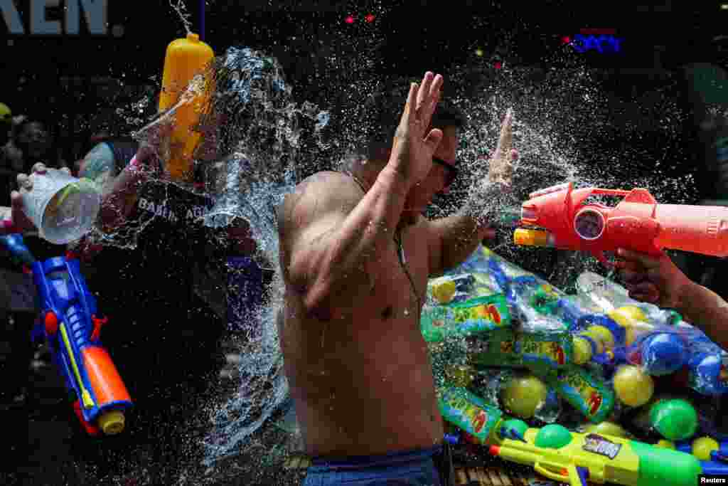 A man is splashed with water as he celebrates the Songkran holiday which marks the Thai New Year in Bangkok, Thailand, April 13, 2024.