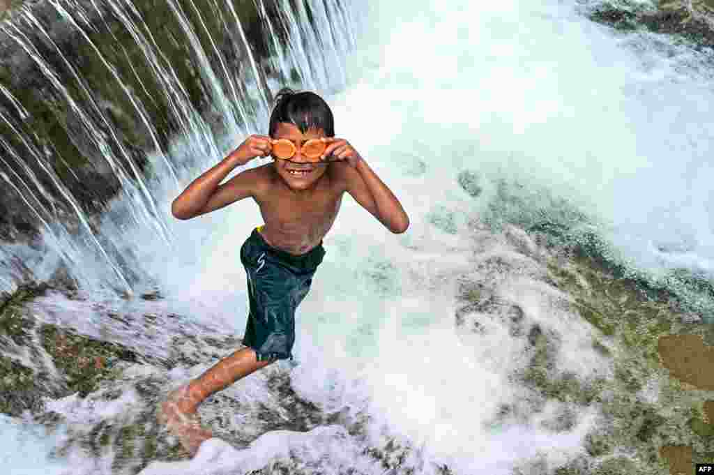 A child puts his swimming goggles on before jumping in a public pool of spring water in Japakeh, Indonesia's Aceh province during World Water Day.