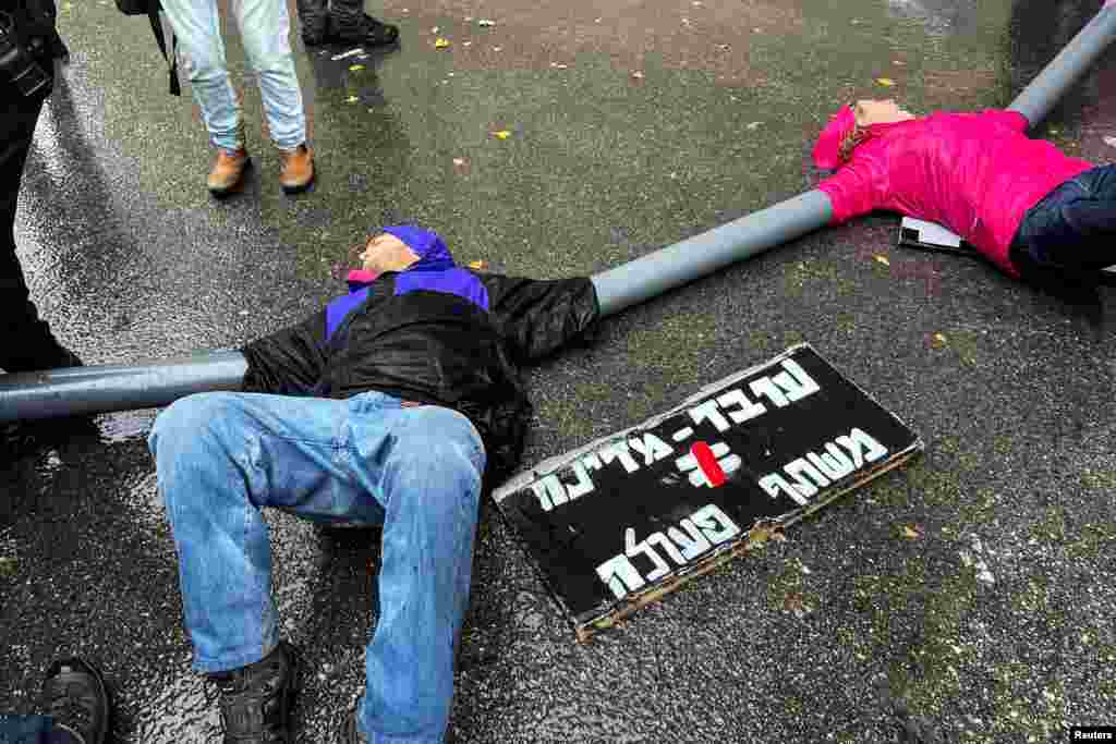 Protesters link themselves with chains and pipes to block the road leading to Israeli Prime Minister Benjamin Netanyahu's office as his nationalist coalition government presses on with its contentious judicial overhaul, in Jerusalem.
