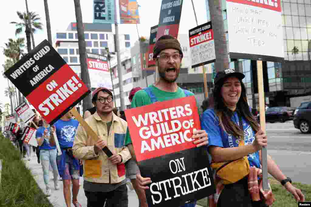Oscar-winning directors Daniel Kwan and Daniel Scheinert march with Writers Guild of America members outside Sunset Bronson Studios and Netflix Studios after union negotiators called a strike for film and television writers, in Los Angeles, California, May 3, 2023.