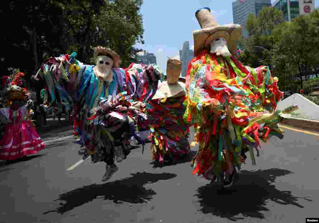 People wearing traditional costumes take part in a march to mark the International Day of the World's Indigenous Peoples, in Mexico City, Mexico, Aug. 9, 2023.