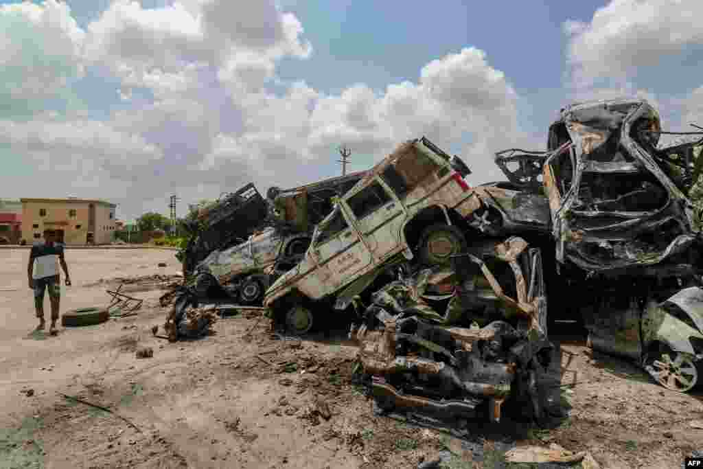 A man walks past burned vehicles after violent communal clashes in Nuh, India. At least four people have been killed in violent clashes between Hindus and Muslims near the capital New Delhi, police said. 