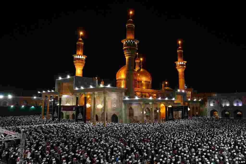 Muslim worshippers perform prayer rituals on Laylat al-Qadr (Night of Destiny), one of the holiest nights during the holy month of Ramadan, at the shrine of Imam Musa al-Kadhim in Baghdad's Kadhimiya neighborhood, Iraq.