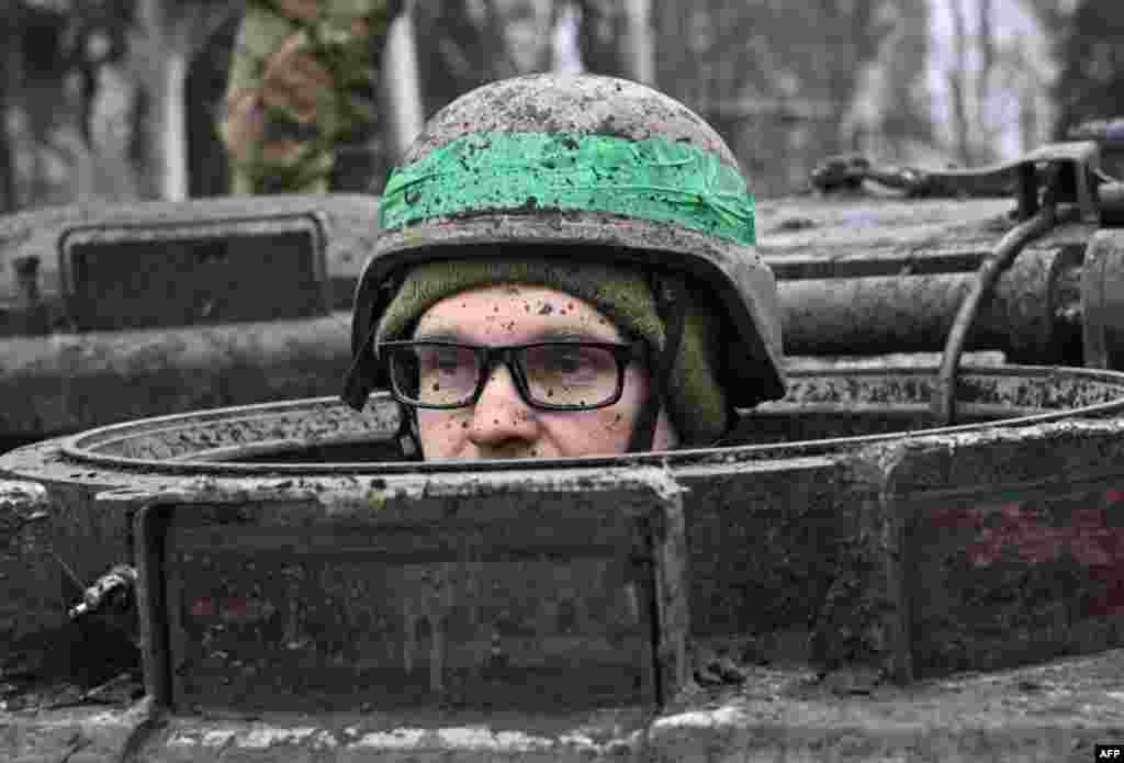 A Ukrainian serviceman looks out of the hatch of an armored personnel carrier, in the town of Chasiv Yar, Donetsk region, amid the Russian invasion of Ukraine.