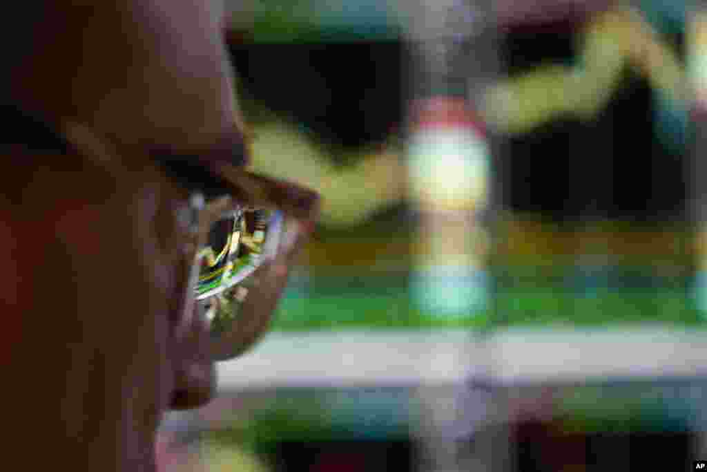 A monitor is reflected off the glasses of a trader working on the floor at the New York Stock Exchange in New York.