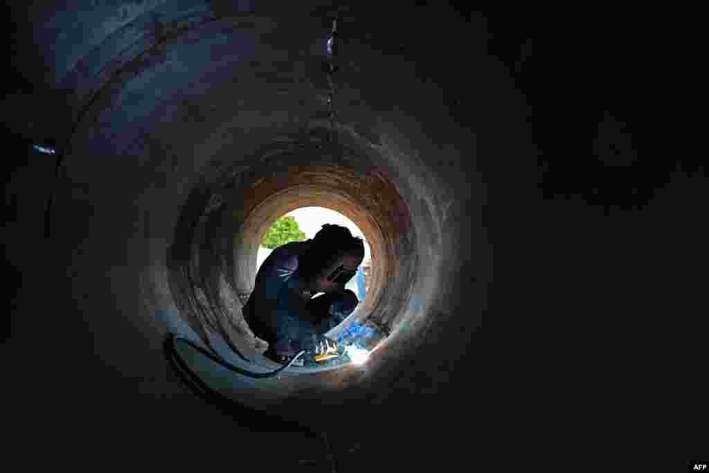 A laborer works at a construction site in Chennai, India.
