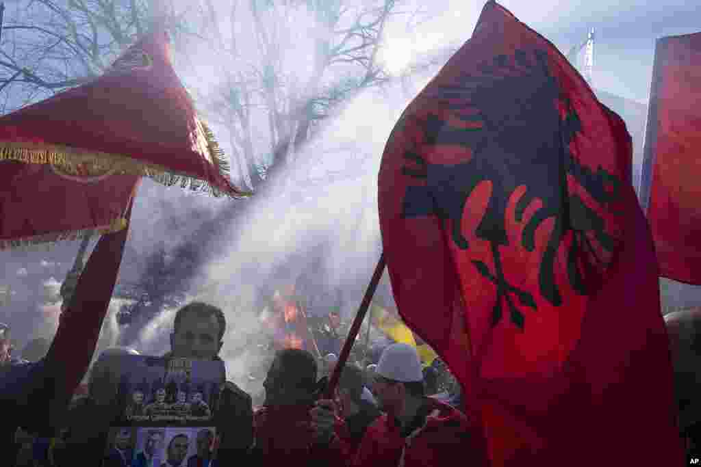 Supporters of former Kosovo president Hashim Thaci and three other defendants protest in The Hague, Netherlands, near the special court where Thaci goes on trial on charges of war crimes and crimes against humanity linked to their roles in Kosovo's war for independence from Serbia in the late 1990s.