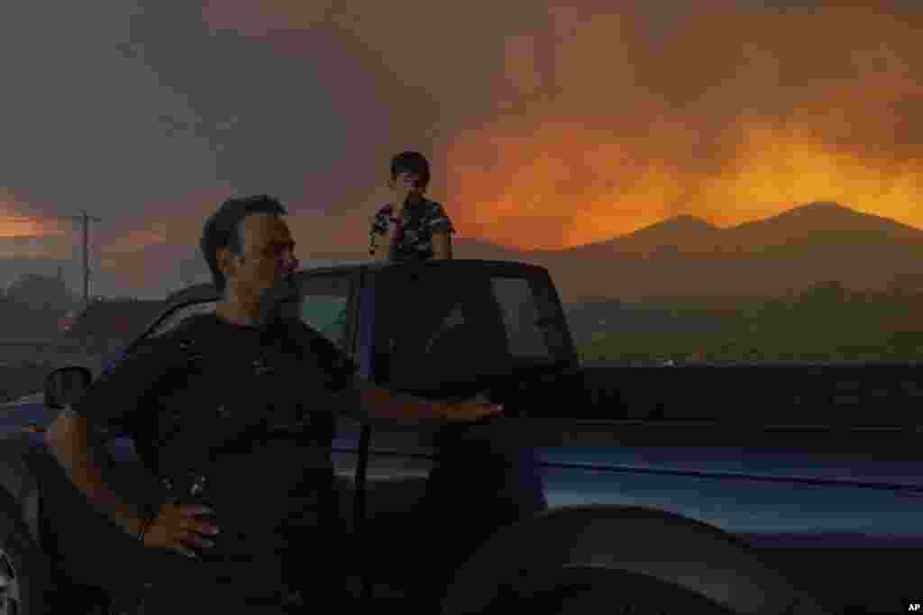 Local residents watch a wildfire in Avantas village, near Alexandroupolis, Greece, Aug. 21, 2023.