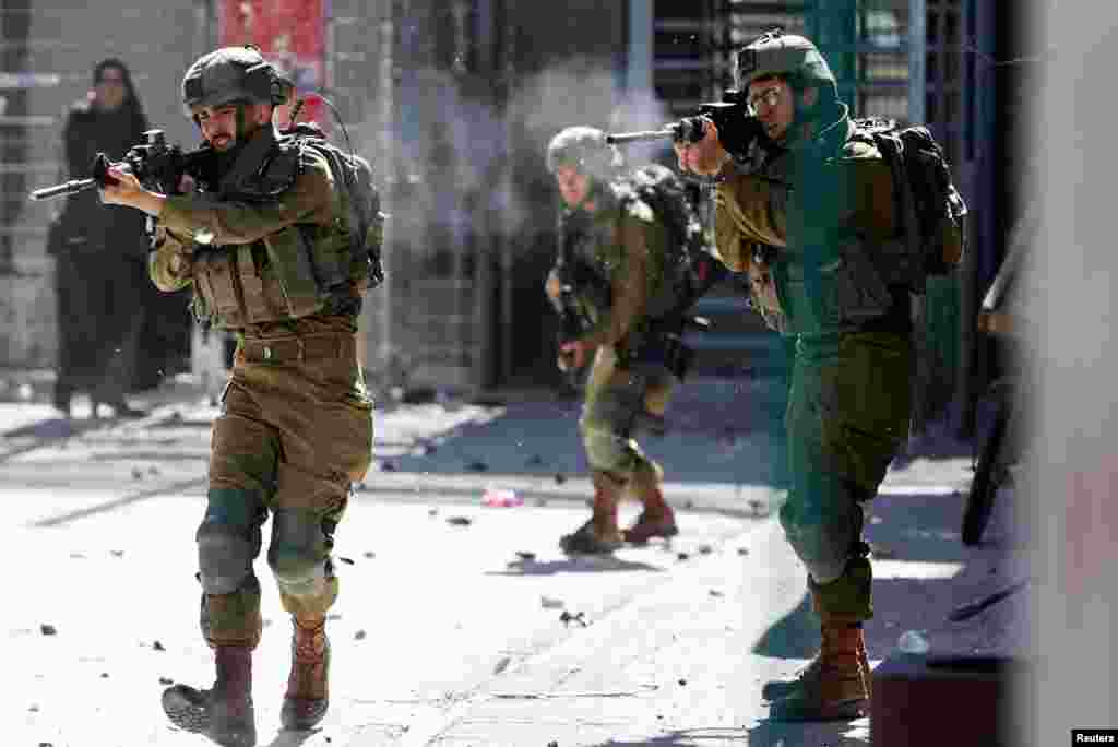 Israeli soldiers shoot rubber bullets at Palestinians during clashes following the death of Palestinian prisoner Khader Adnan during a hunger strike in an Israeli jail, in Hebron in the Israeli-occupied West Bank. 