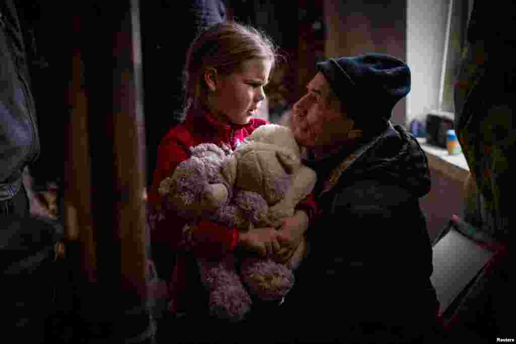 A grandfather says goodbye to his granddaughter Arina, 6, before her evacuation from front line city of Bakhmut, amid Russia's attack on Ukraine, in Donetsk region, Ukraine, Jan. 31, 2023. Arina is one of an estimated 11 million people displaced by the war in Ukraine, according to U.N. figures, that began when Russia invaded in February 2022. The grandparents initially said they did not want the little girl to leave - but eventually concluded it would be for the best. 