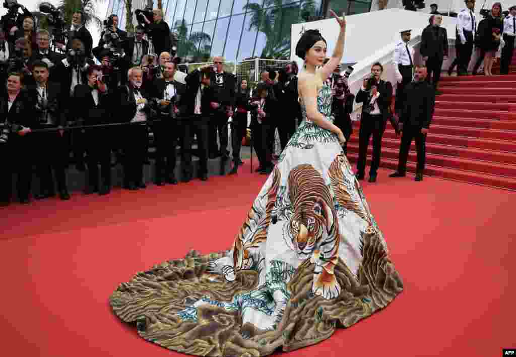 Chinese actress Fan Bingbing waves as she arrives for the screening of the film "Jeanne Du Barry" during the 76th edition of the Cannes Film Festival in Cannes, southern France.