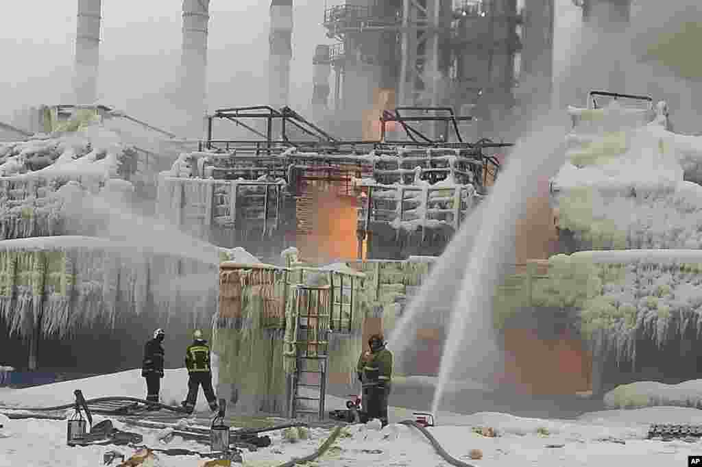 In this photo released by Telegram Channel of head of the Kingisepp district administration Yuri Zapalatskiy, fire fighters extinguish the blaze at Russia's second-largest natural gas producer, Novatek in Ust-Luga, 165 kilometers southwest of St. Petersburg, Russia. Fire broke out at the chemical transport terminal following two explosions, regional officials reported.