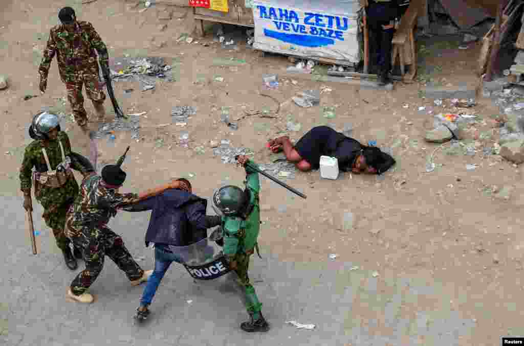 Riot police accost a supporter of Kenya's opposition leader Raila Odinga during a protest of the imposition of tax hikes by the government, in the Mlolongo settlement of Machakos county.