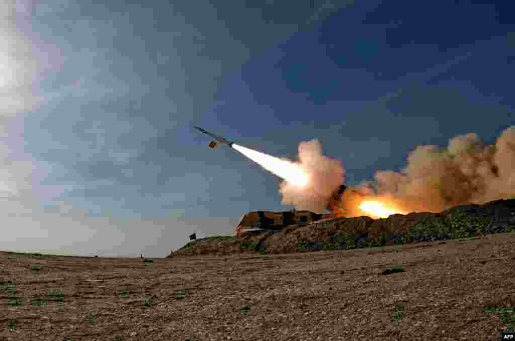 A handout picture provided by the Iranian Army media office shows the launch of a missile during a military drill at an undisclosed location in southern Iran. (Photo by Iranian Army office / AFP)