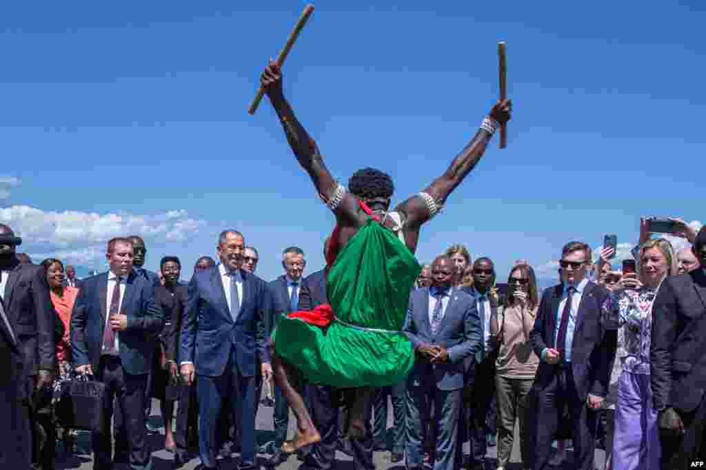 Russian Foreign Minister Sergey Lavrov (C-L) and Burundi Foreign Minister Albert Nshingiro (C-R) look on as Lavrov is welcomed by Burundian traditional drummers upon his arrival at the Melchior Ndadaye International Airport in Bujumbra. 