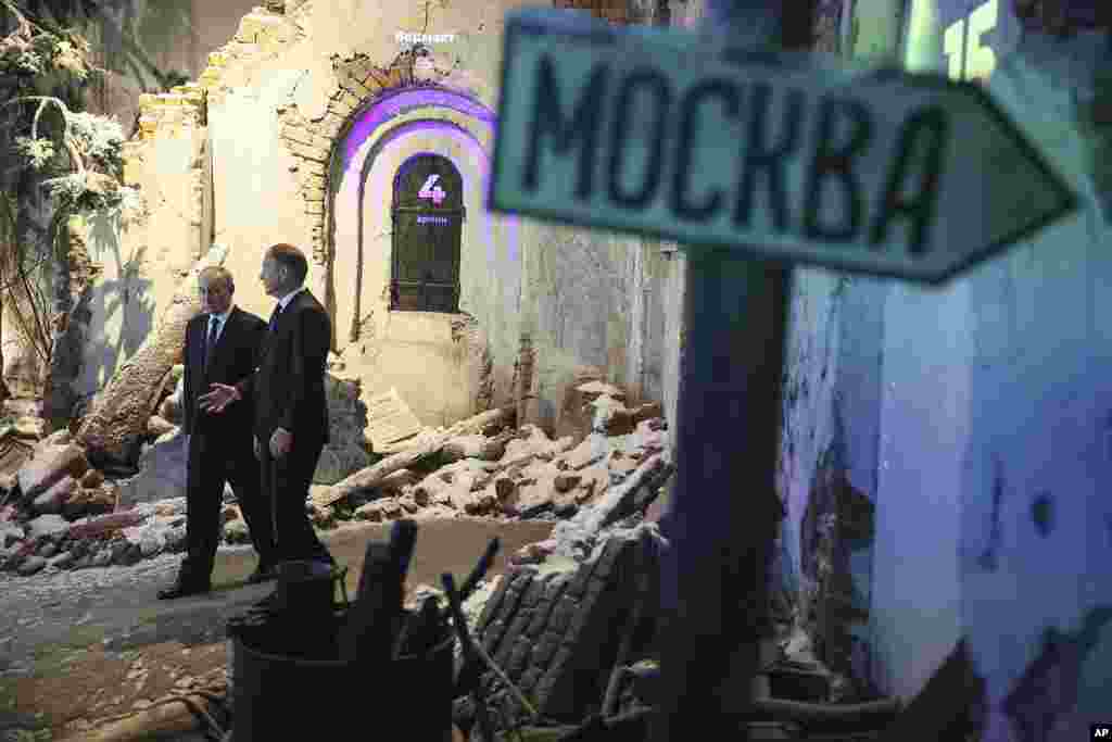 Russian President Vladimir Putin, left, accompanied by Victory Museum Director Alexander Shkolnik, visits the Victory Museum in Moscow, Russia.