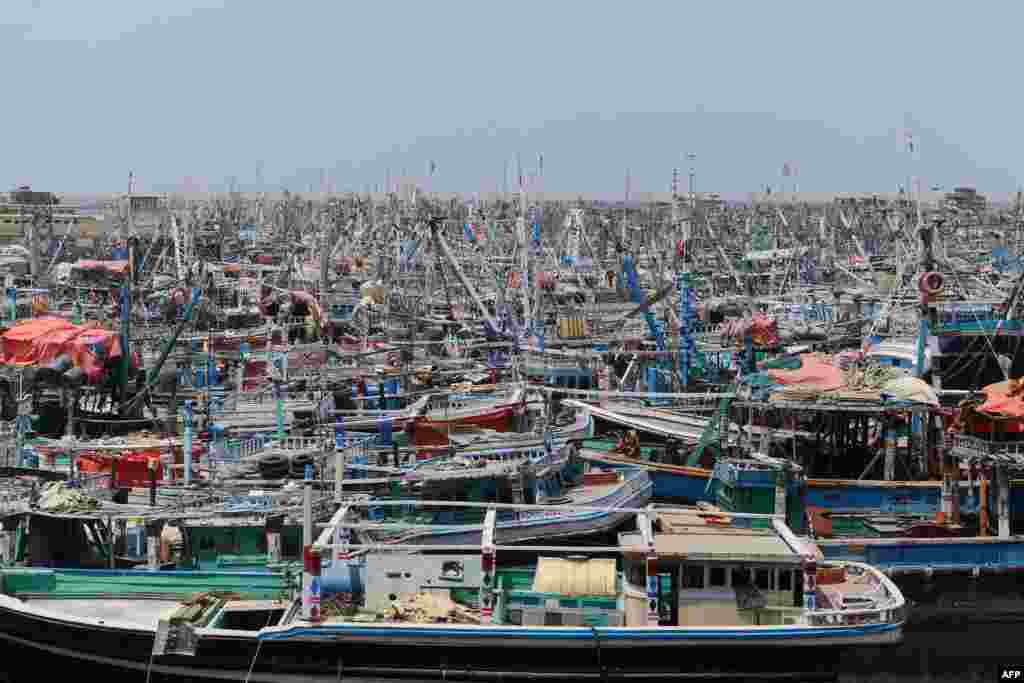 Fishing boats are moored at Karachi port as a part of precautionary measures before the expected onset of a cyclone, in Karachi, Pakistan. More than 40,000 people have been evacuated across India and Pakistan as a cyclone approaches their coast, officials said, with gales of up to 150 kilometers per hour predicted.