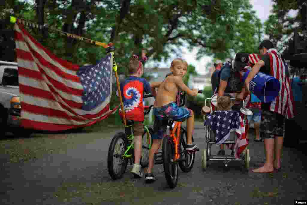 Boys on bikes lead residents' local Fourth of July Parade in the Lanesville neighborhood of Gloucester, Massachusetts, July 4, 2023.