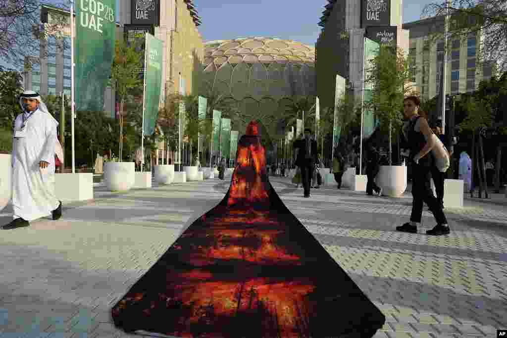 Islene Facanha of Portugal participates in a demonstration dressed with images of wildfires at the COP28 U.N. Climate Summit, in Dubai, United Arab Emirates.