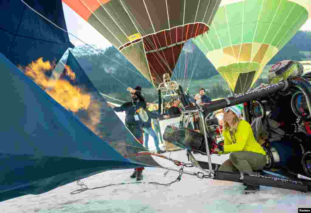 Pilot Amanda Brodbeck prepares her balloon during the 44th International Hot Air Balloon Festival in Chateau-d'Oex, Switzerland.