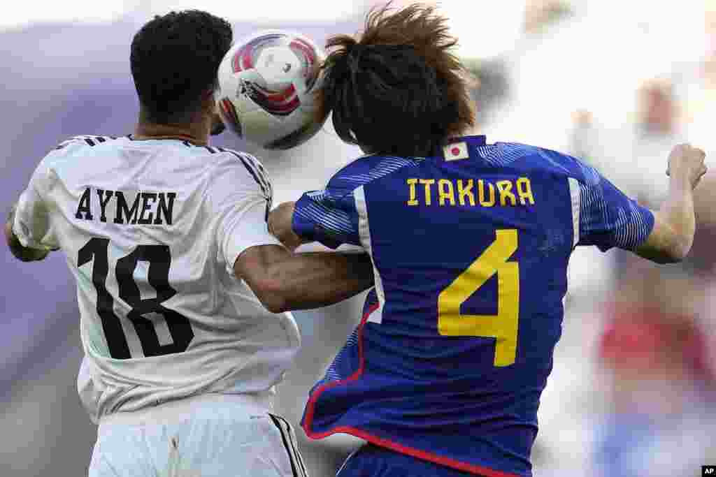 Iraq's Aymen Hussein, left, and Japan's Kou Itakura jump for the ball during the Asian Cup Group C soccer match between Iraq and Japan at the Education City Stadium in Al Rayyan, Qatar.