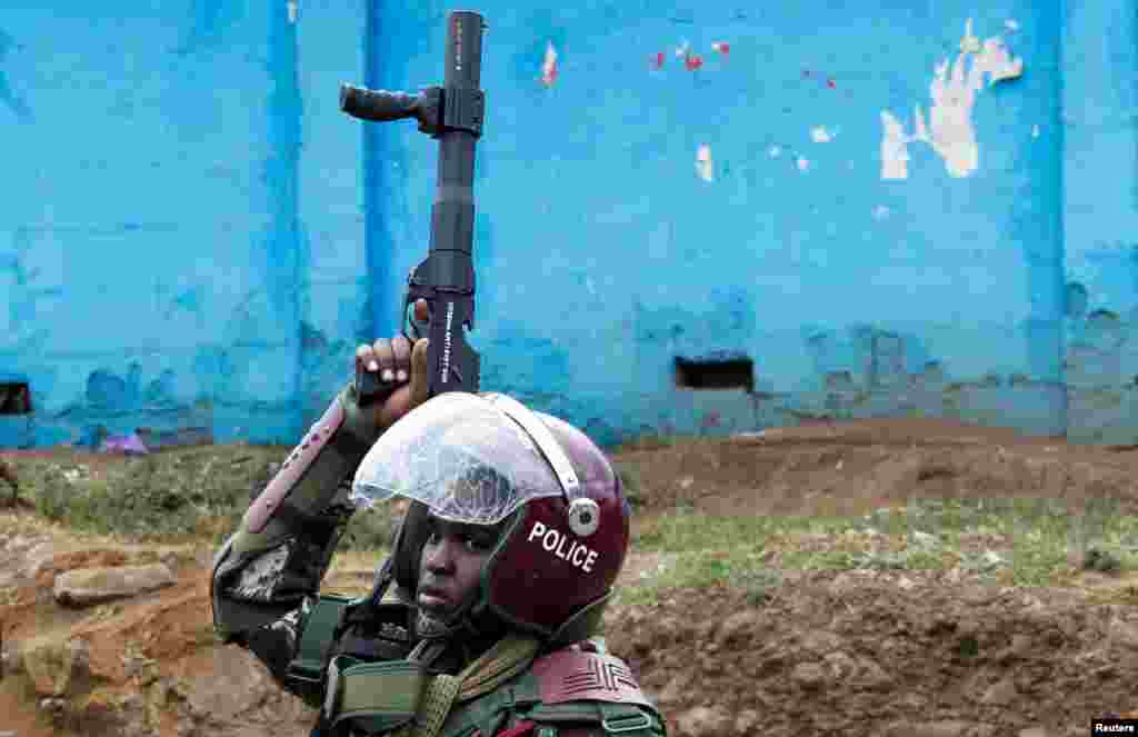 A riot police officer carries his gun after dispersing supporters of Kenya's opposition leader Raila Odinga of the Azimio La Umoja (Declaration of Unity) One Kenya Alliance, during an anti-government protest dubbed "Saba Saba (7th of July) People's March," in Nairobi, Kenya.