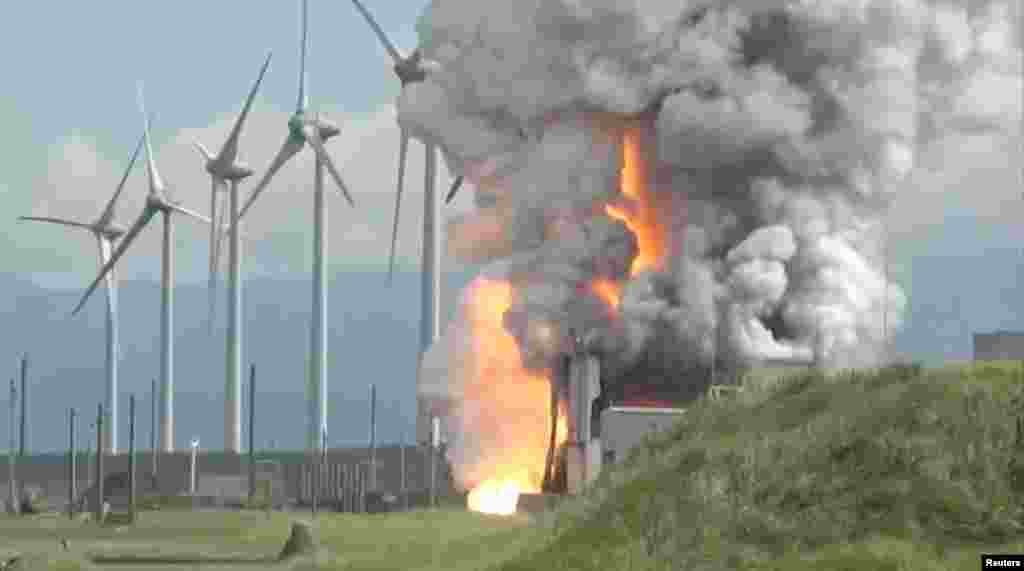 Smoke rises following the explosion of a rocket engine during a test in Noshiro City, Akita Prefecture, Japan, in this screengrab taken from a handout video. (nvs-live.com/Handout via Reuters)