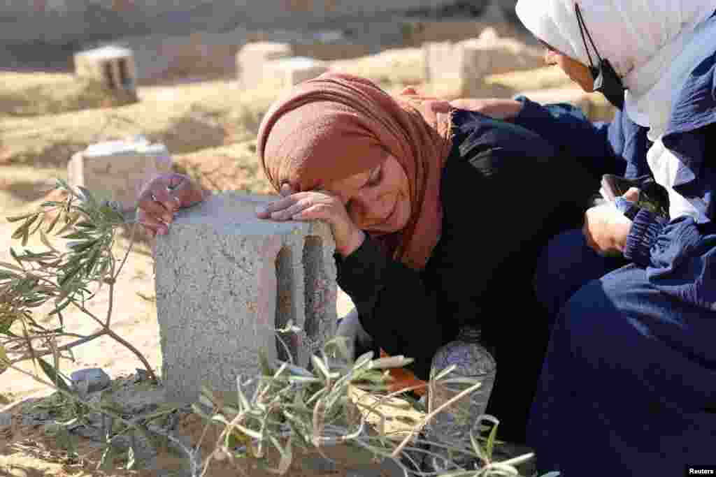 A Palestinian woman reacts at the grave of her son killed in an Israeli strike, in Khan Younis in the southern Gaza Strip.