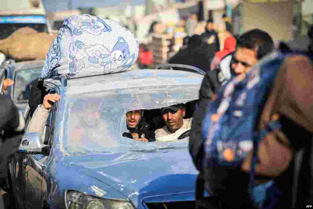 This photograph taken on the southern outskirts of Khan Yunis in the southern Gaza Strip shows Palestinian families fleeing the city on the coastal road leading to Rafah. The Israeli army bombarded Khan Yunis after Israeli Prime Minister rejected what he said were Hamas conditions for the release of hostages, even amid mounting pressure from their families. 