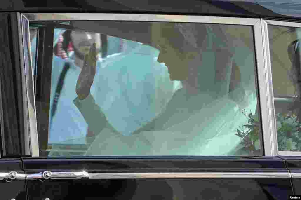 Rajwa Al Saif waves from a car on the day of her wedding to Crown Prince Hussein, in Amman, Jordan.