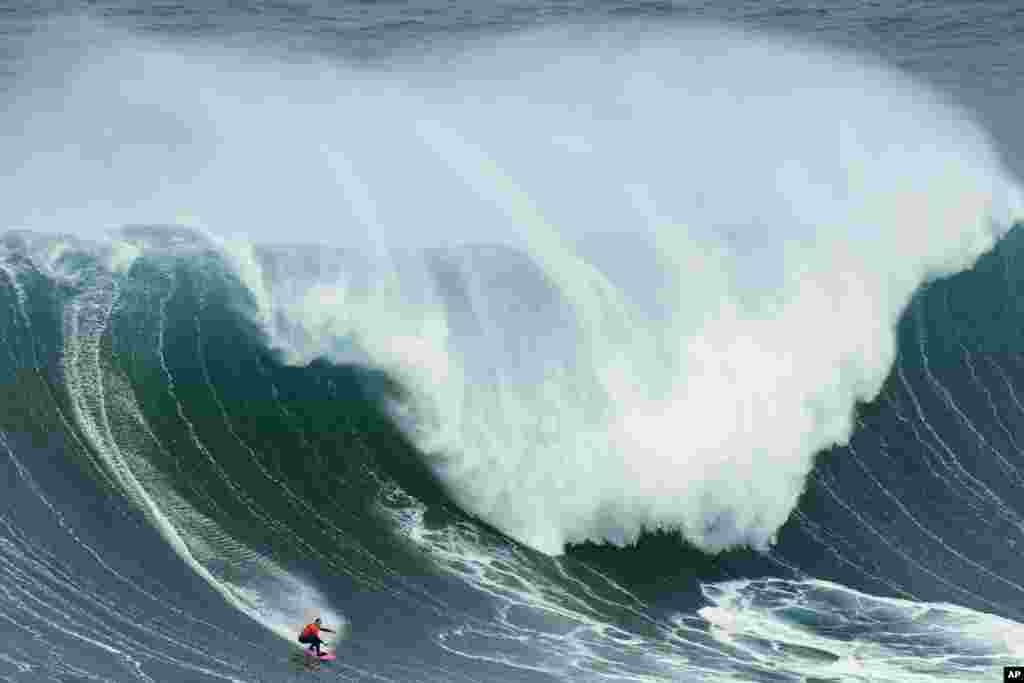 Maya Gabeira from Brazil rides a wave during the Nazare Big Wave Challenge surfing tournament at Praia do Norte, or North Beach, in Nazare, Portugal.