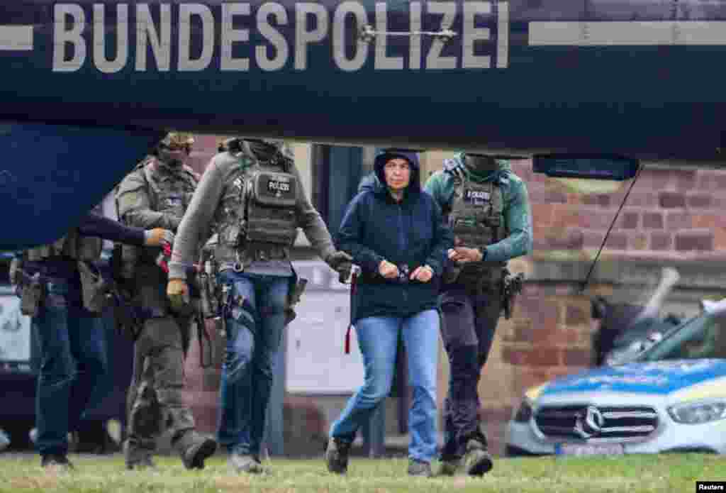 Daniela Klette, a 65-year-old member of Germany's notorious Red Army Faction (RAF) militant group, who has been arrested after decades on the run for armed robbery and attempted murder is brought to a helicopter, on the day of her appearance before German Federal Public Prosecutor, in Karlsruhe.