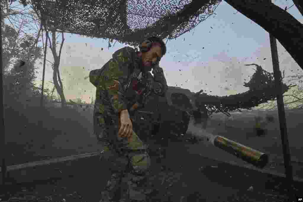 A Ukrainian serviceman of the 10th Assault Brigade Edelweiss fires a D-30 cannon towards Russian positions at the front line, near Bakhmut, Donetsk region, Ukraine, July 5, 2023.