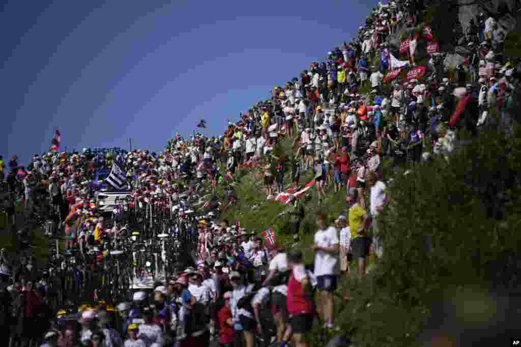 Team cars and motorcycles got stuck in the crowd on the Col de la Loze pass during the seventeenth stage of the Tour de France cycling race over 166 kilometers (103 miles) with start in Saint-Gervais Mont-Blanc and finish in Courchevel, France. 