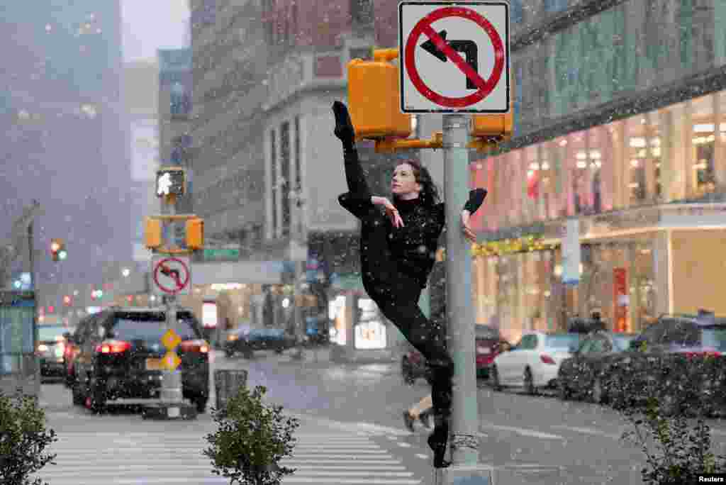 Dancer Skye Madison Murphy poses for a photographer as snow falls in New York City, Jan. 6, 2024.