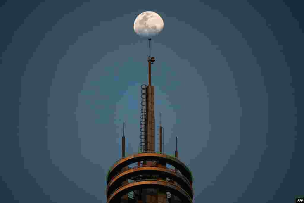 The moon is pictured above a building in Kuala Lumpur, Malaysia.