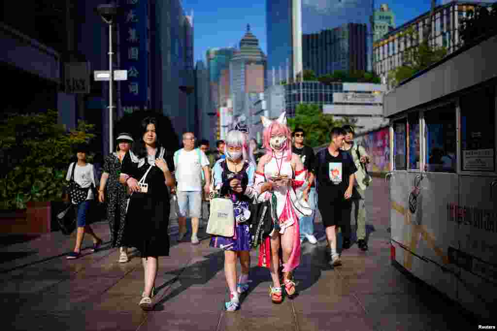 Cosplayers walk on a shopping street, in Shanghai, China.