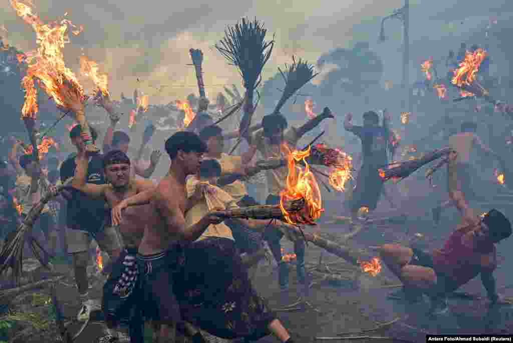 Hindu worshipers take part in the 'Perang Api,' a war of fire tradition that is believed for cleansing the evil elements and keeping away from misfortune, in Mataram, Lombok island, Indonesia.