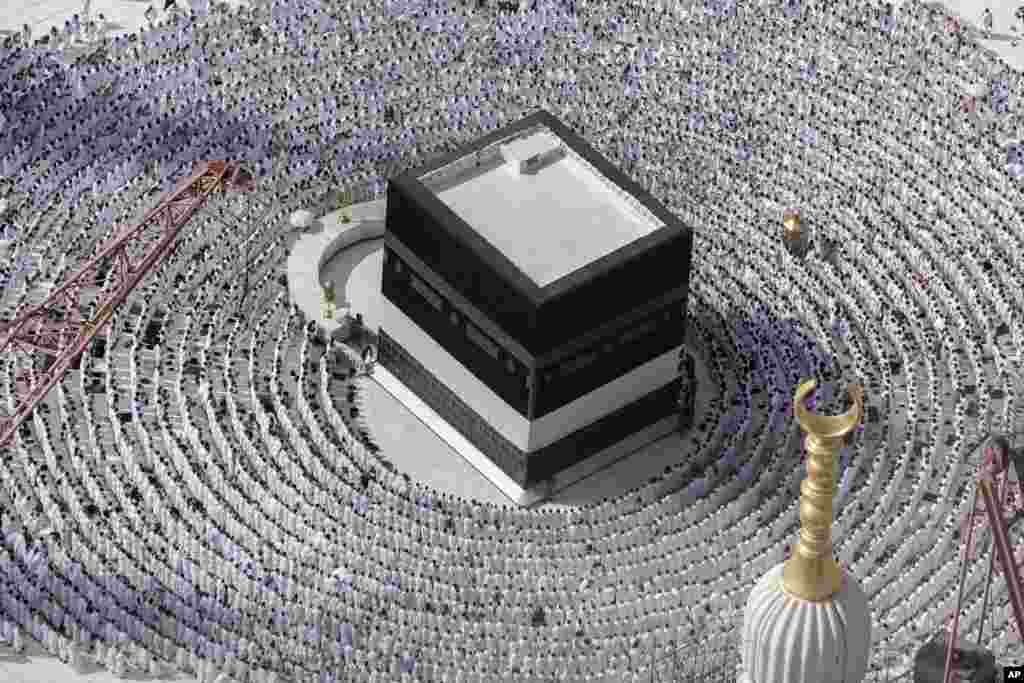 Muslim pilgrims pray around the Kaaba, the cubic building at the Grand Mosque, during the annual Hajj pilgrimage in Mecca, Saudi Arabia.