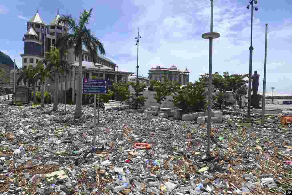 Debris washed up during the cyclone is strewn across the Caudan Waterfront in Port Louis, the capital city of Mauritius. Mauritius lifted its highest weather alert and eased a nationwide curfew after a cyclone battered the Indian Ocean island, causing heavy flooding and extensive damage in the capital city and other parts of the country.