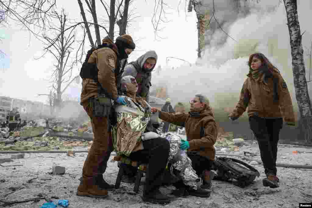 Medical workers treat a wounded local resident at a site of residential buildings heavily damaged during a Russian missile attack, in Kharkiv, Ukraine.