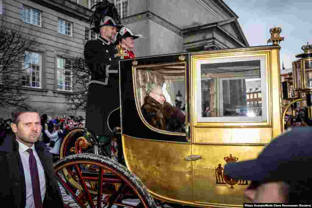 Denmark's Queen Margrethe is escorted by the Gardehusar Regiment's Horseskort in the golden carriage in Copenhagen.