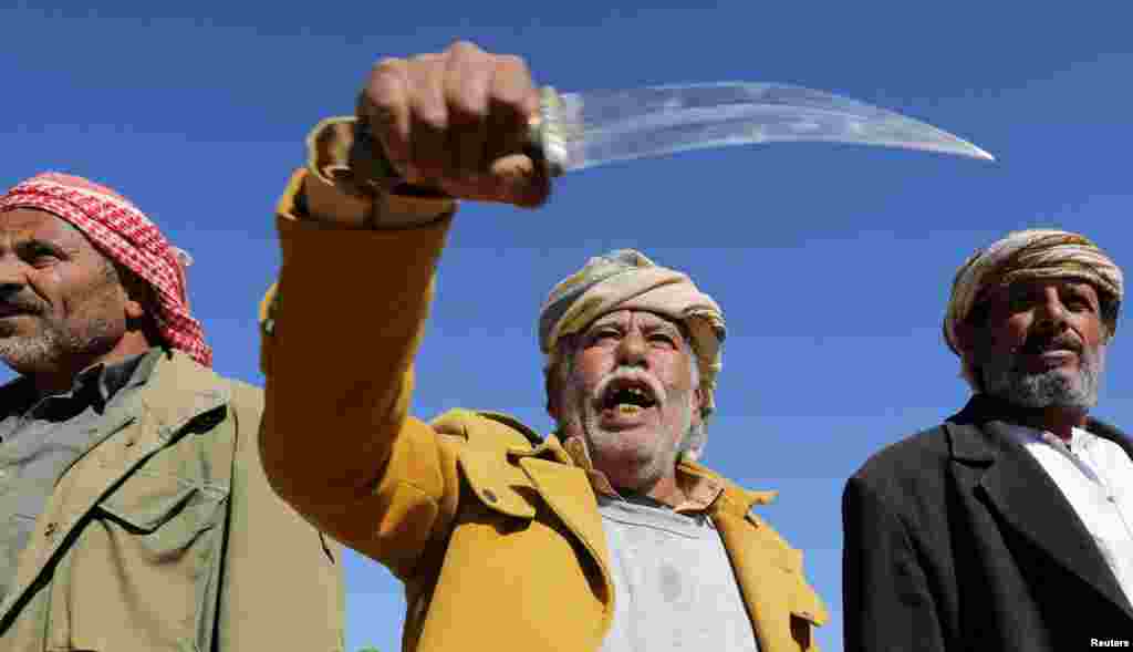 A tribal supporter of Yemen's Houthis hold his traditional dagger, or jambiya, during a protest against recent U.S.-led strikes on Houthi targets, near Sanaa.