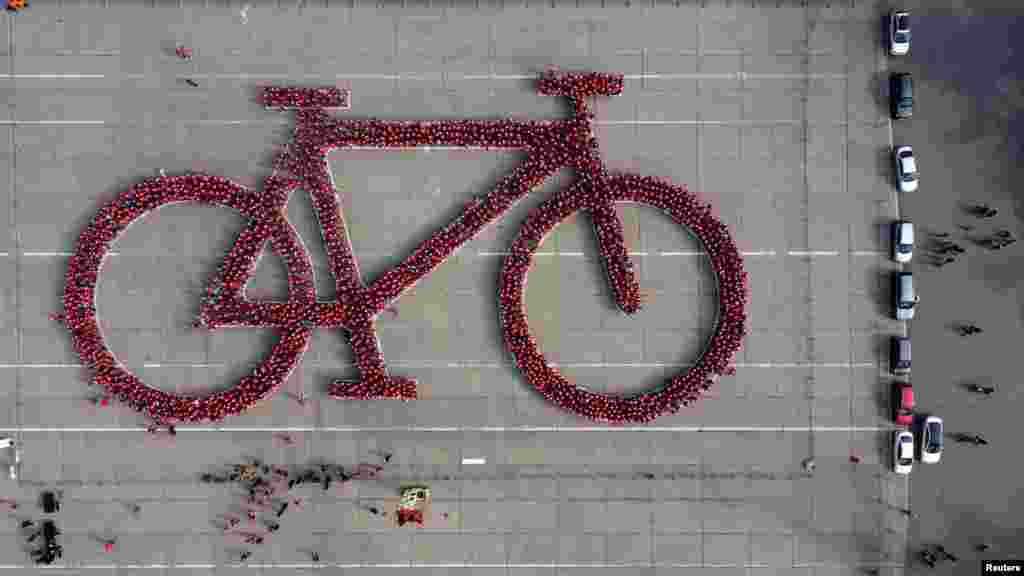 Local residents make a formation in the shape of a bicycle in an attempt to do the world's largest bicycle as part of a Bicycle Festival, in Santiago, Chile, May 27, 2023.