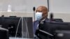 FILE - Kenyan lawyer Paul Gicheru listens to charges against him in the case against President William Ruto at the opening hearing at the International Criminal Court in The Hague, Netherlands, Feb. 15, 2022. 