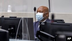 FILE - Kenyan lawyer Paul Gicheru listens to charges against him in the case against President William Ruto at the opening hearing at the International Criminal Court in The Hague, Netherlands, Feb. 15, 2022. 