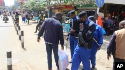 A day after declaration of presidential election results, police officers patrol streets of Kenya's capital Nairobi, Aug. 16, 2022, after William Ruto was declared 5th president of Kenya Monday by the Electoral Commission.