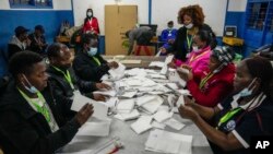 Election officials count votes at a polling station in Kilimera Primary School in Nairobi, Kenya, Aug. 9, 2022. 