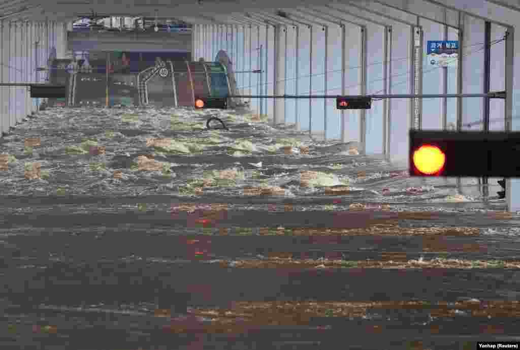 A bridge is submerged by torrential rain of the previous day at Han river in Seoul, South Korea.